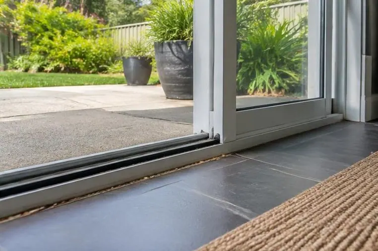 Open patio door with a ground-level threshold gap