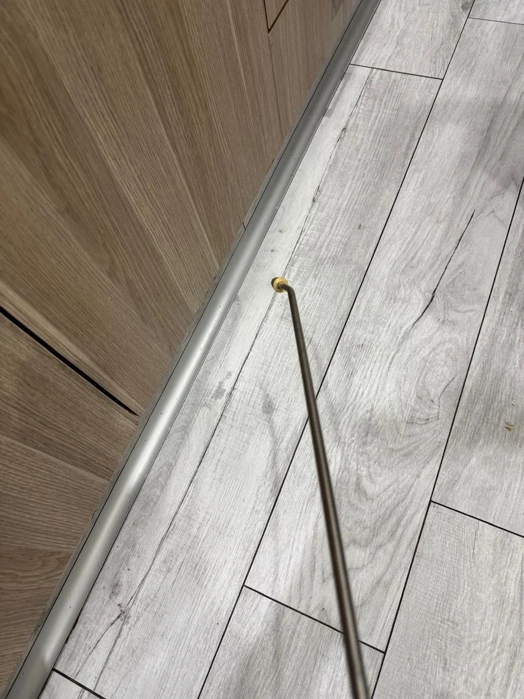 Treatment lance applying product into a gap beside kitchen cabinets