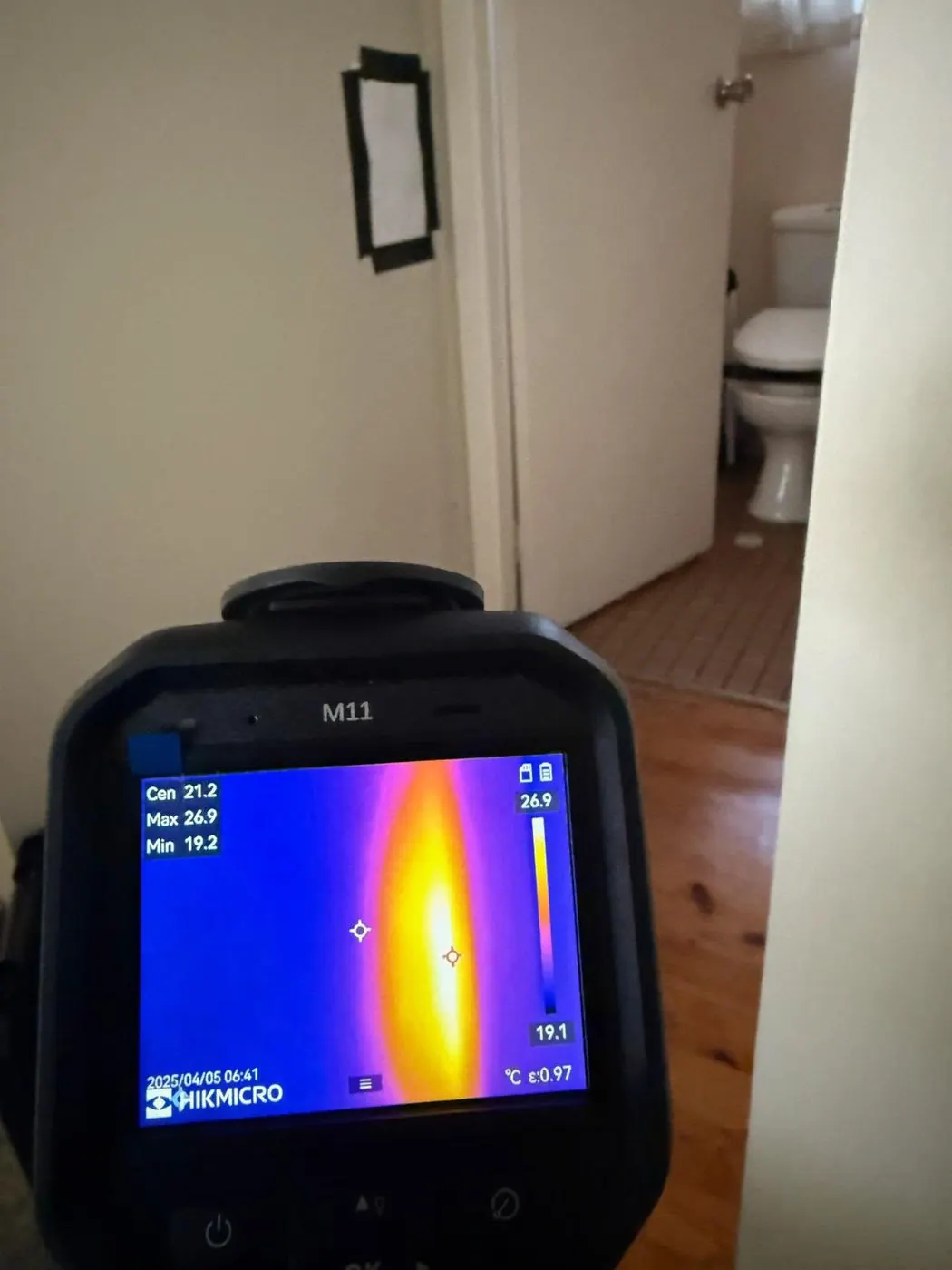 Thermal imaging camera detecting a heat signature inside a Sydney wall
